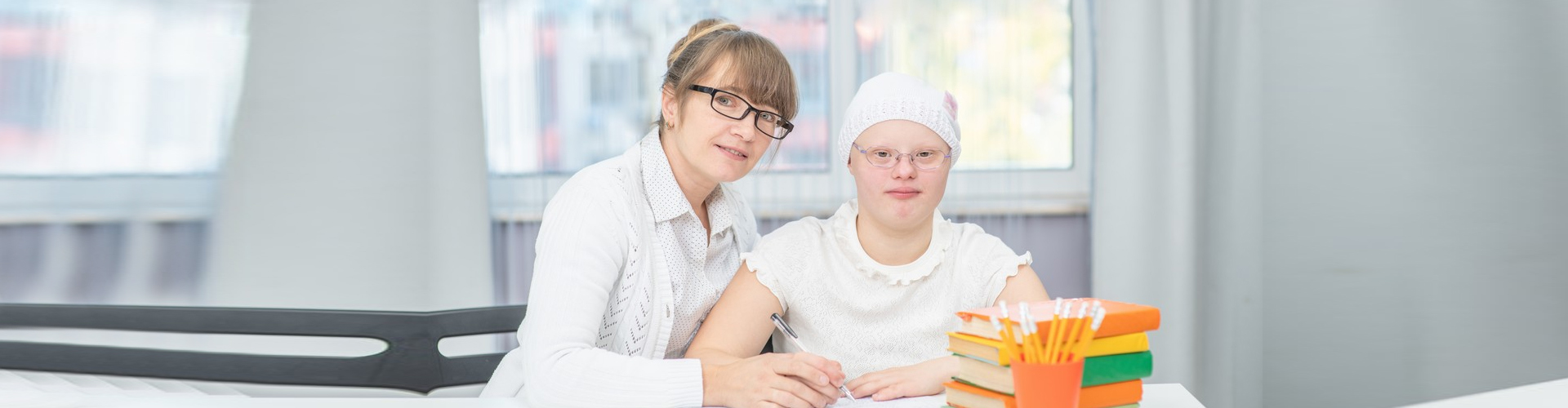 caregiver and a child writting